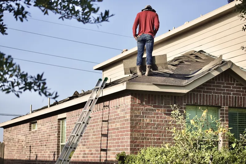 Professional roofer working on a residential roof in Dillard
